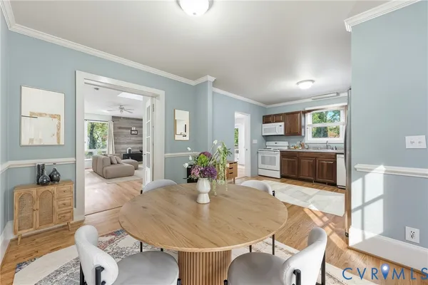 a living room with fireplace furniture and a kitchen view