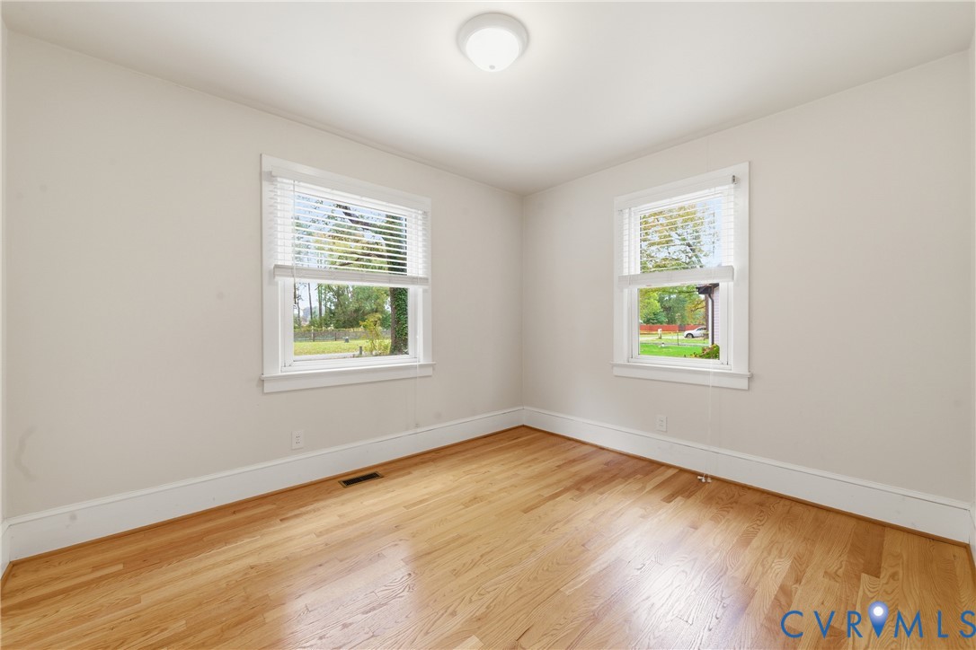 8325 Mill Creek Road West Point, VA 23181 - Photo 18 of 50 a view of an empty room with wooden floor and a window