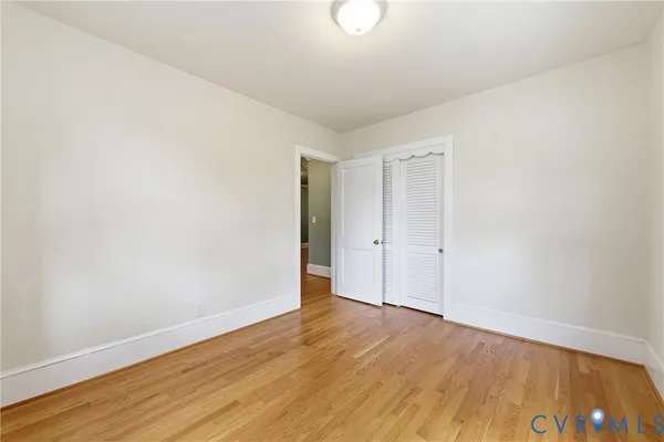 a view of an empty room with wooden floor