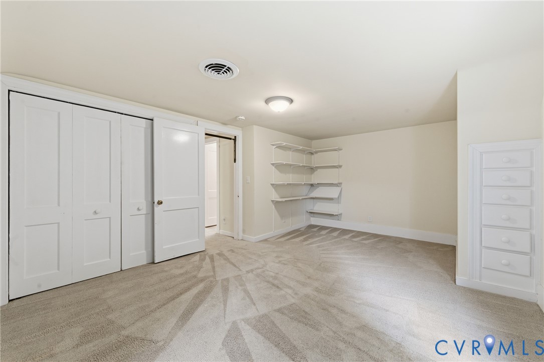 8325 Mill Creek Road West Point, VA 23181 - Photo 24 of 50 a view of a room with walk in closet and empty racks