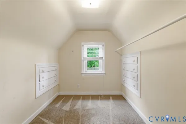 an empty room with windows and cabinet