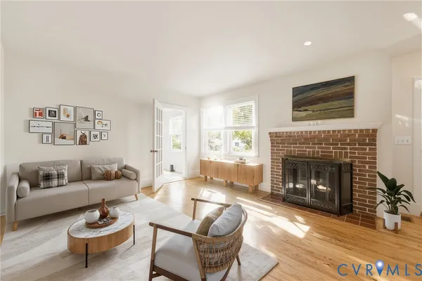 a living room with furniture and a fireplace