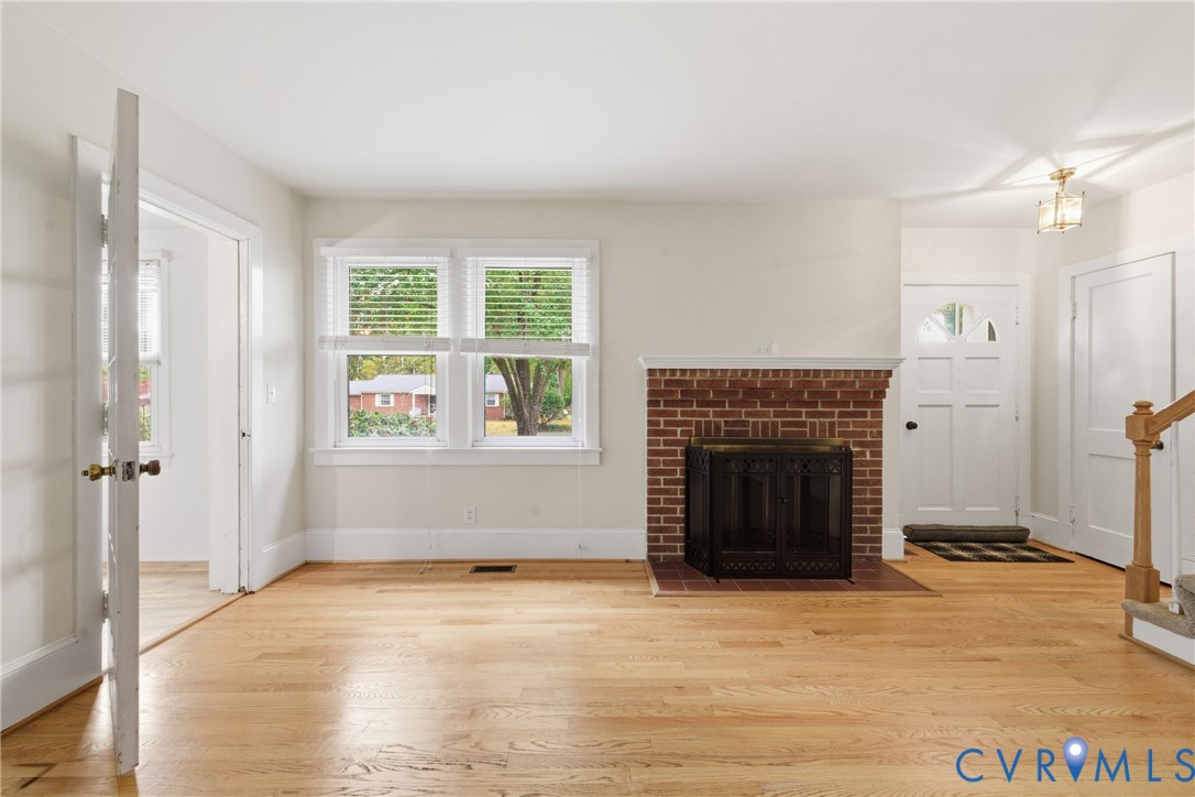 8325 Mill Creek Road West Point, VA 23181 - Photo 6 of 50 an empty room with windows and fireplace