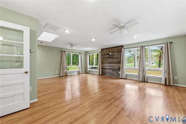 a view of a livingroom with wooden floor and window