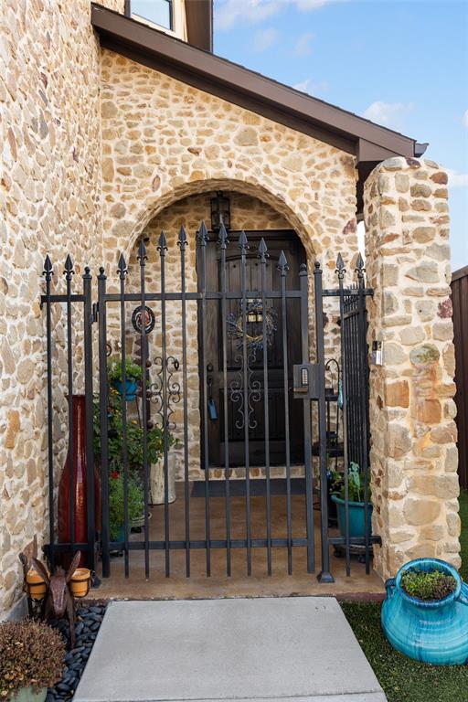 3105 Pastor Street Dallas, TX 75212 - Photo 11 of 28 View of front courtyard with decorative iron fence before entering home