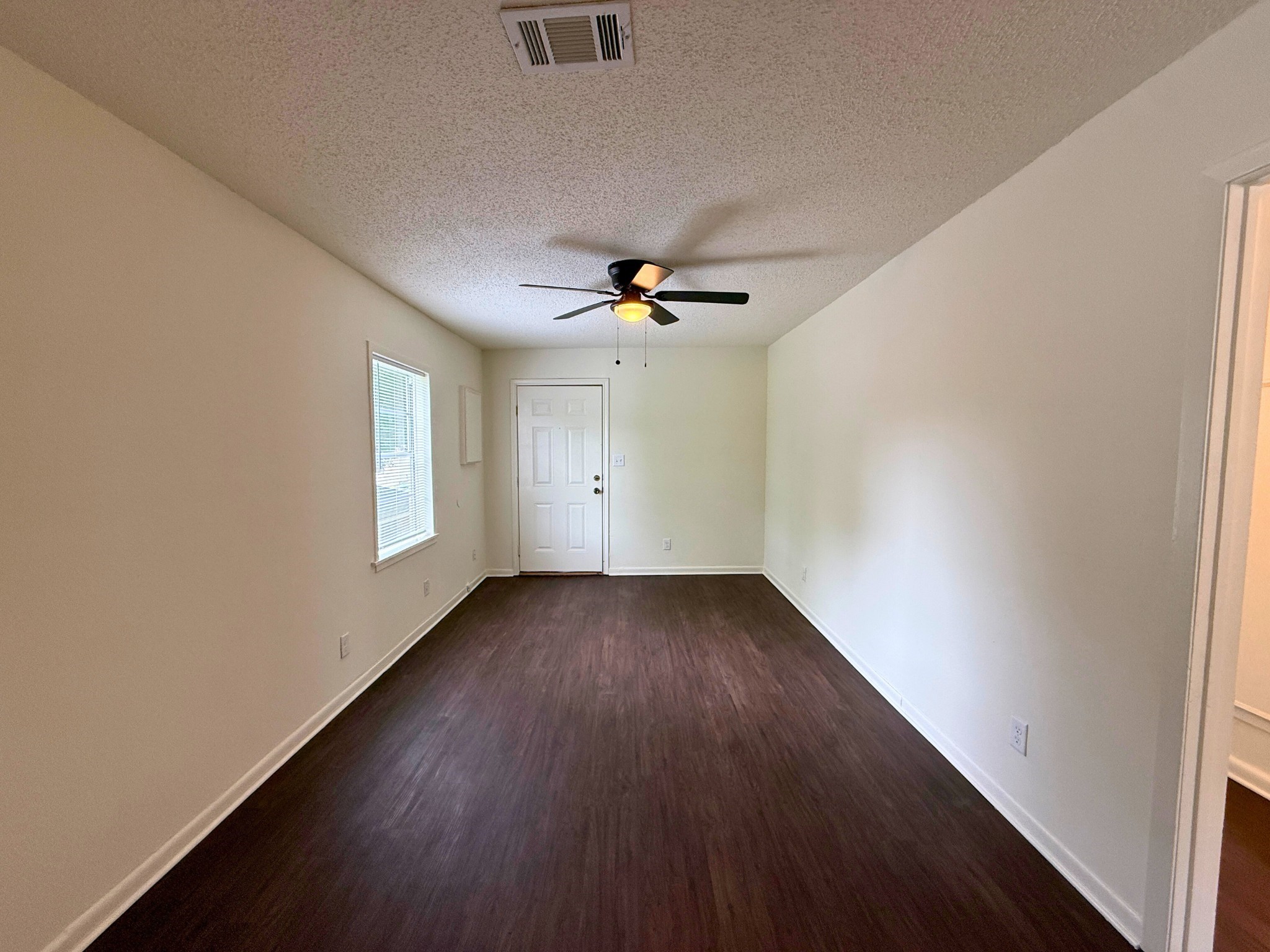 214 Crawford Street Huntsville, TX 77340 - Photo 15 of 24 wooden floor in an empty room with a window