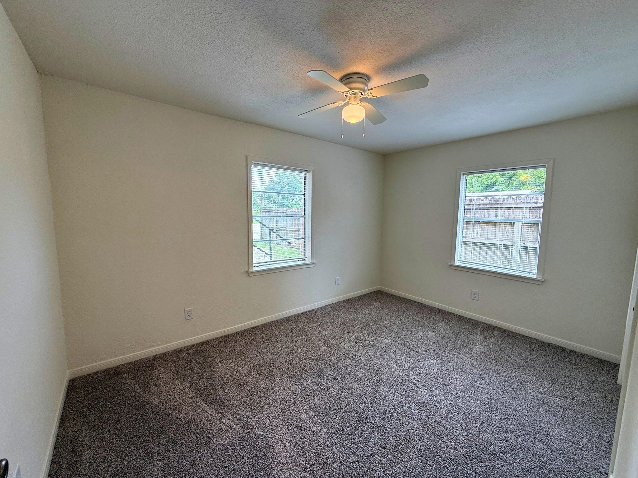 214 Crawford Street Huntsville, TX 77340 - Photo 7 of 24 an empty room with windows and fan