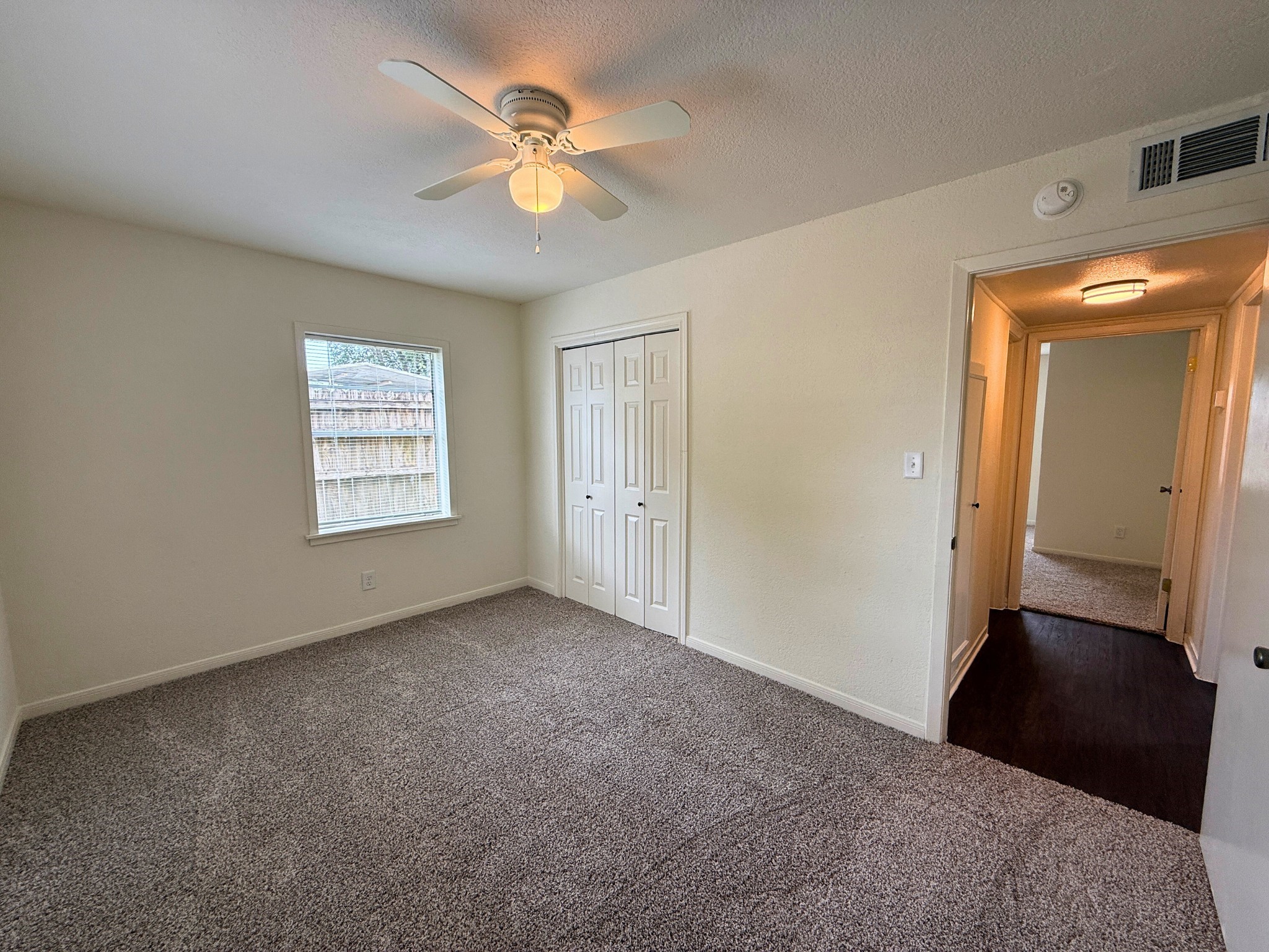 214 Crawford Street Huntsville, TX 77340 - Photo 8 of 24 an empty room with windows and fan