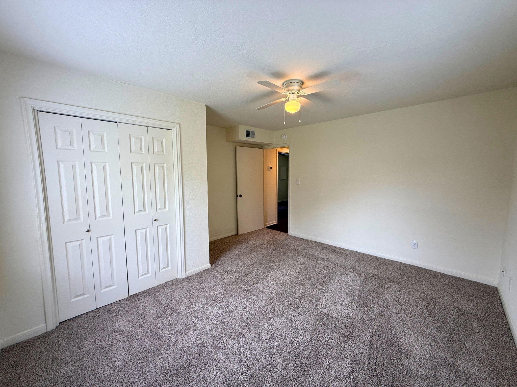 214 Crawford Street Huntsville, TX 77340 - Photo 10 of 24 an empty room with a window and a fan