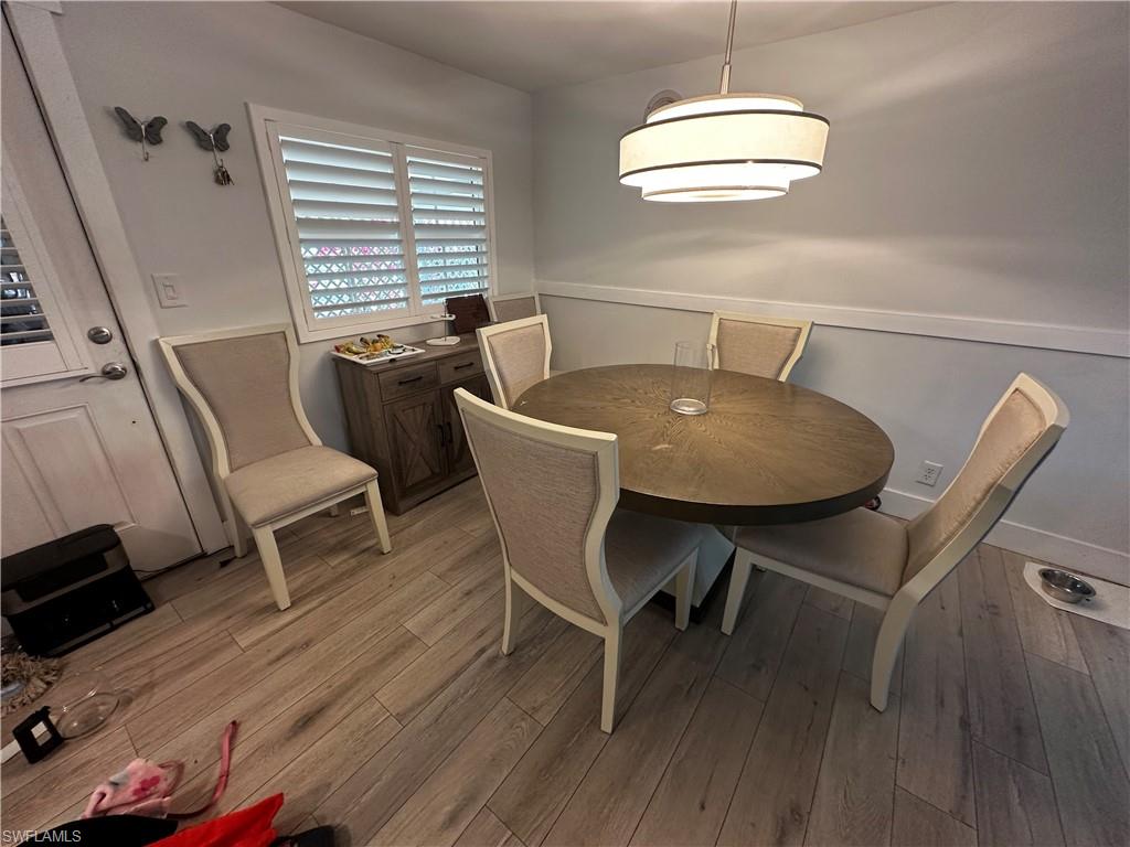 170 Pine Key Lane, Unit 13 Naples, FL 34114 - Photo 12 of 34 Dining space with light wood-type flooring