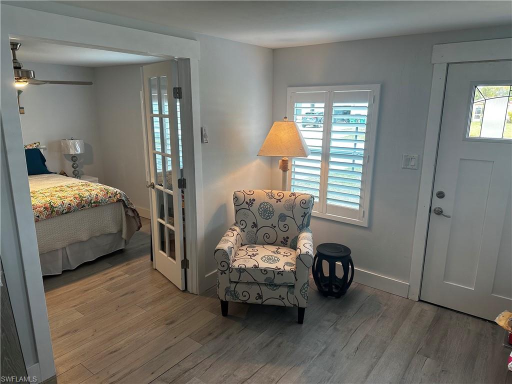 170 Pine Key Lane, Unit 13 Naples, FL 34114 - Photo 13 of 34 Entryway with wood finished floors, ceiling fan, and healthy amount of natural light