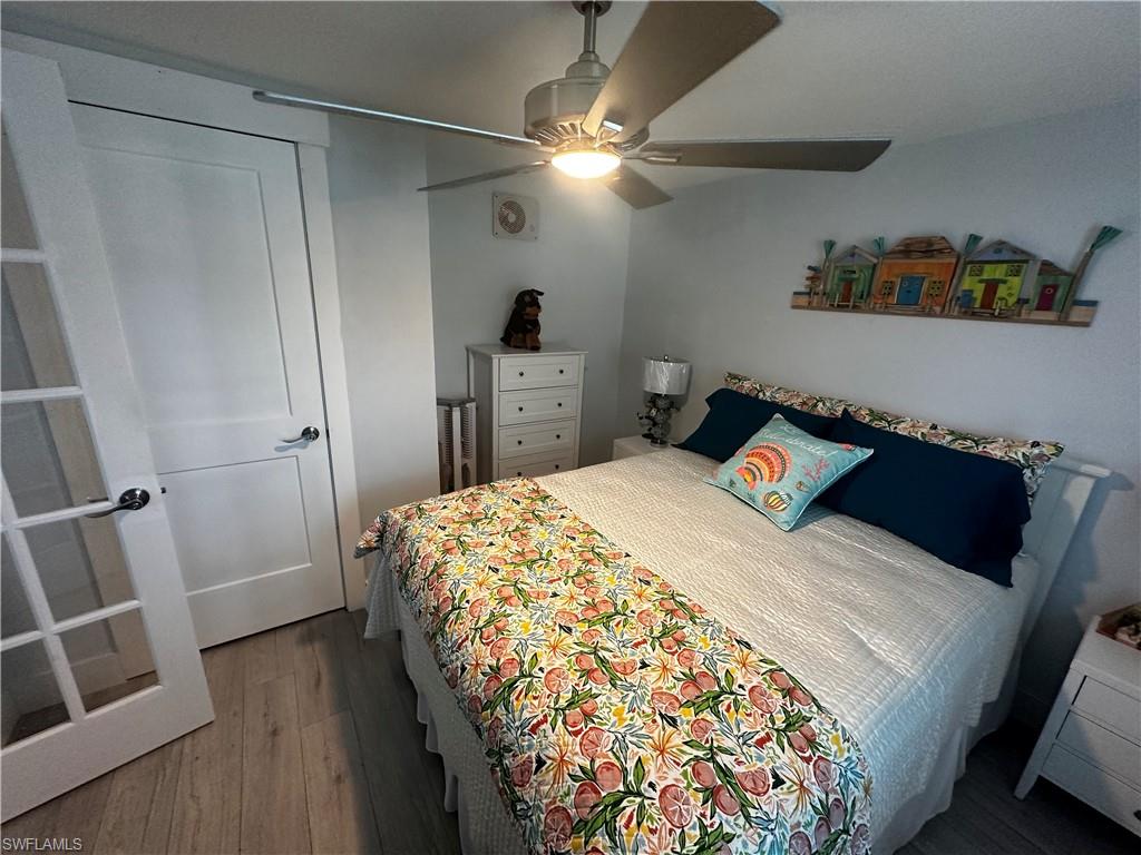 170 Pine Key Lane, Unit 13 Naples, FL 34114 - Photo 15 of 34 Bedroom featuring dark wood-type flooring and a ceiling fan