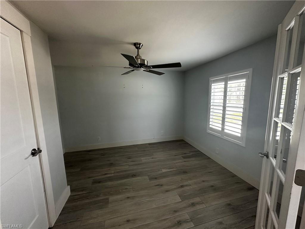 170 Pine Key Lane, Unit 13 Naples, FL 34114 - Photo 22 of 34 Unfurnished room featuring dark wood-style floors and a ceiling fan