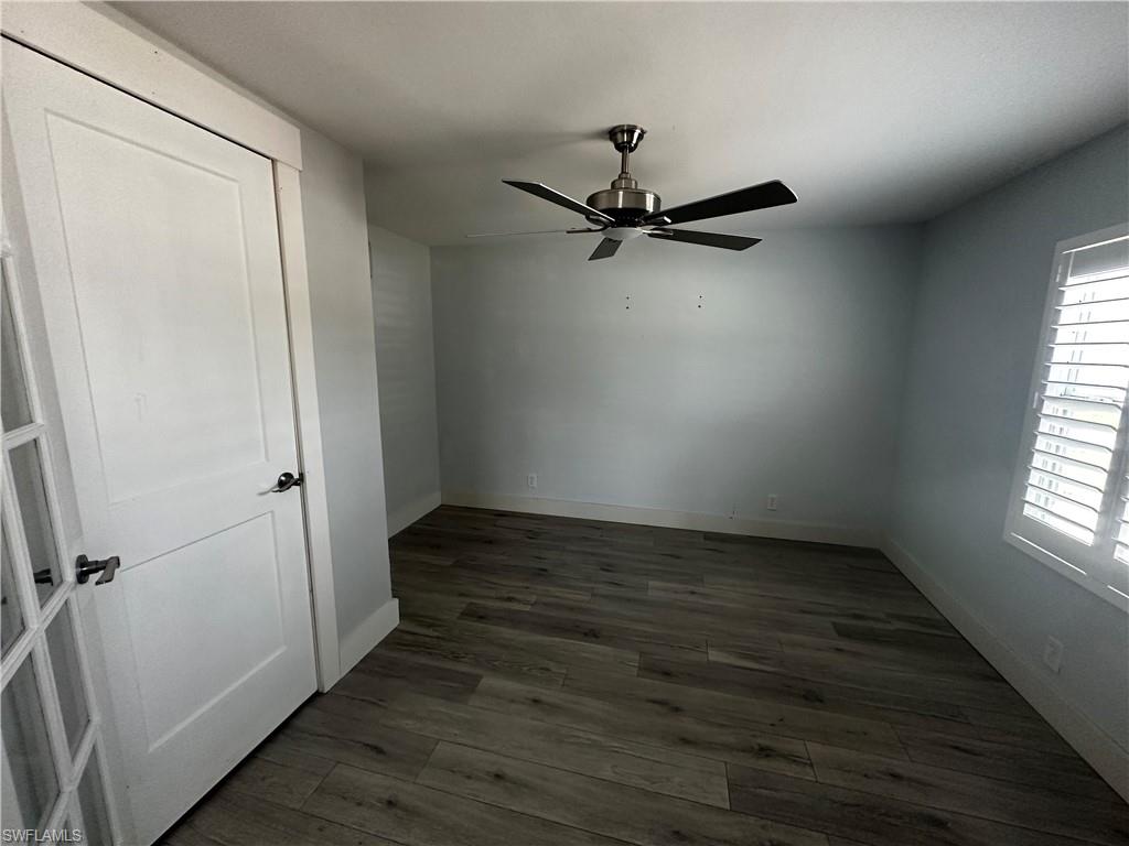 170 Pine Key Lane, Unit 13 Naples, FL 34114 - Photo 23 of 34 Unfurnished bedroom with dark wood-style floors and ceiling fan