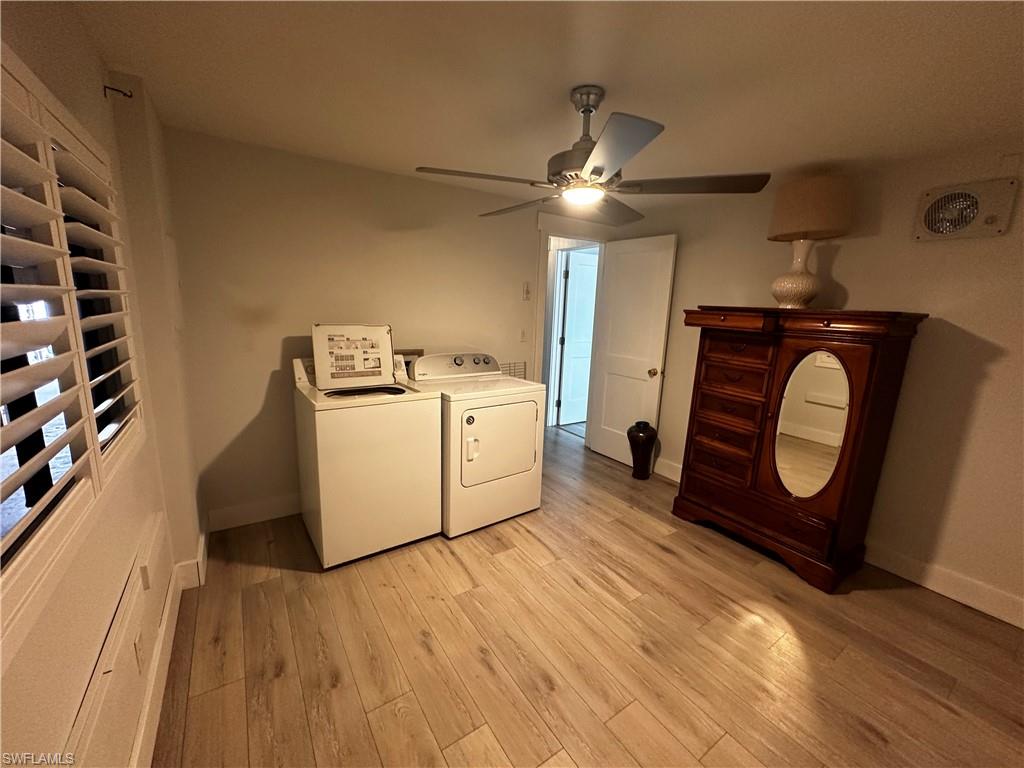 170 Pine Key Lane, Unit 13 Naples, FL 34114 - Photo 29 of 34 Laundry area featuring independent washer and dryer, light wood-type flooring, and a ceiling fan