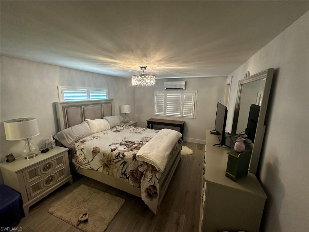 170 Pine Key Lane, Unit 13 Naples, FL 34114 - Photo 4 of 34 Bedroom with wood finished floors