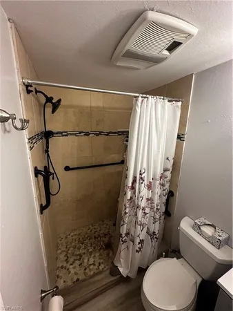 a bathroom with a toilet sink and shower