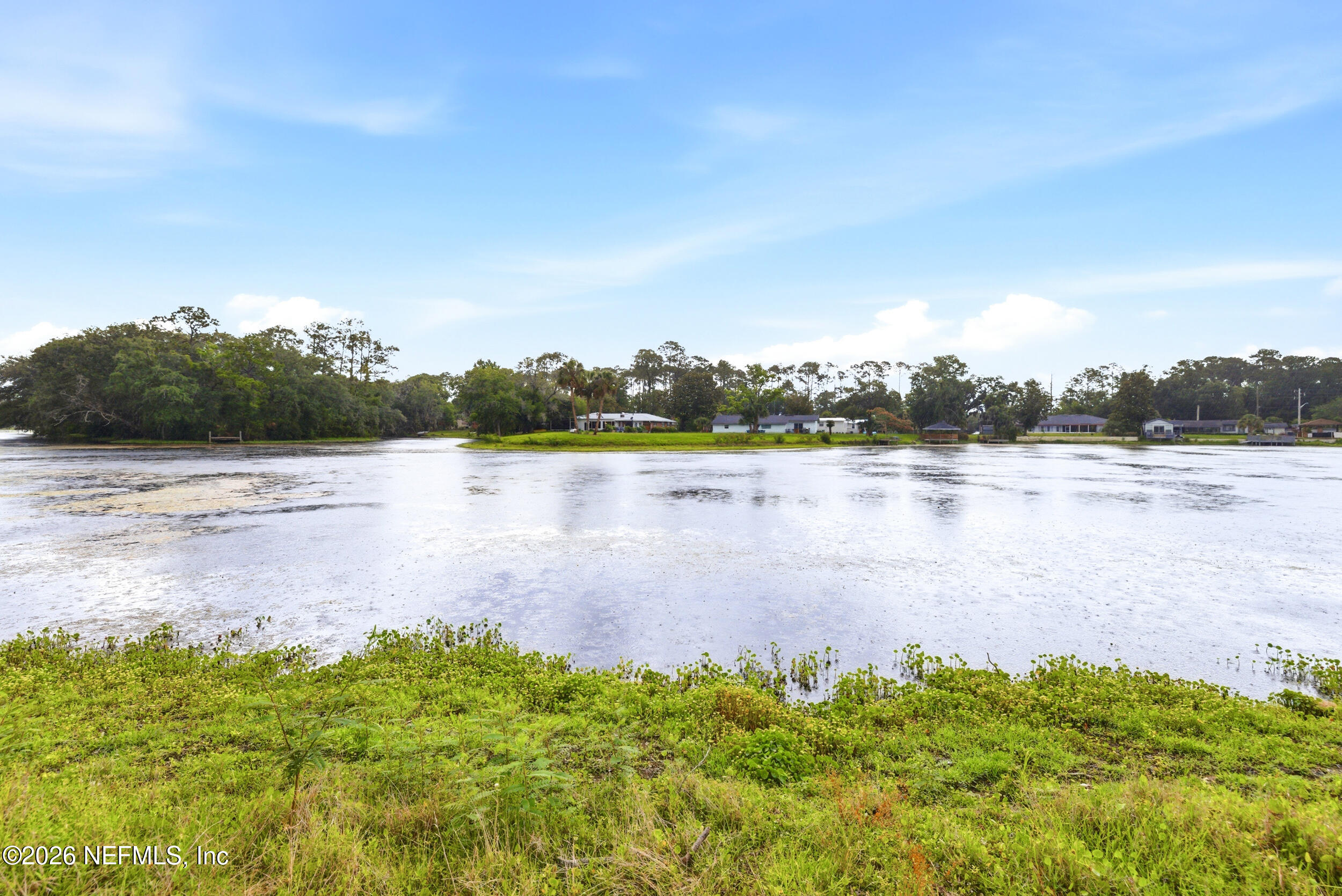 7484 Spinola Road Jacksonville, FL 32217 - Photo 61 of 63 a view of a lake with houses in the back