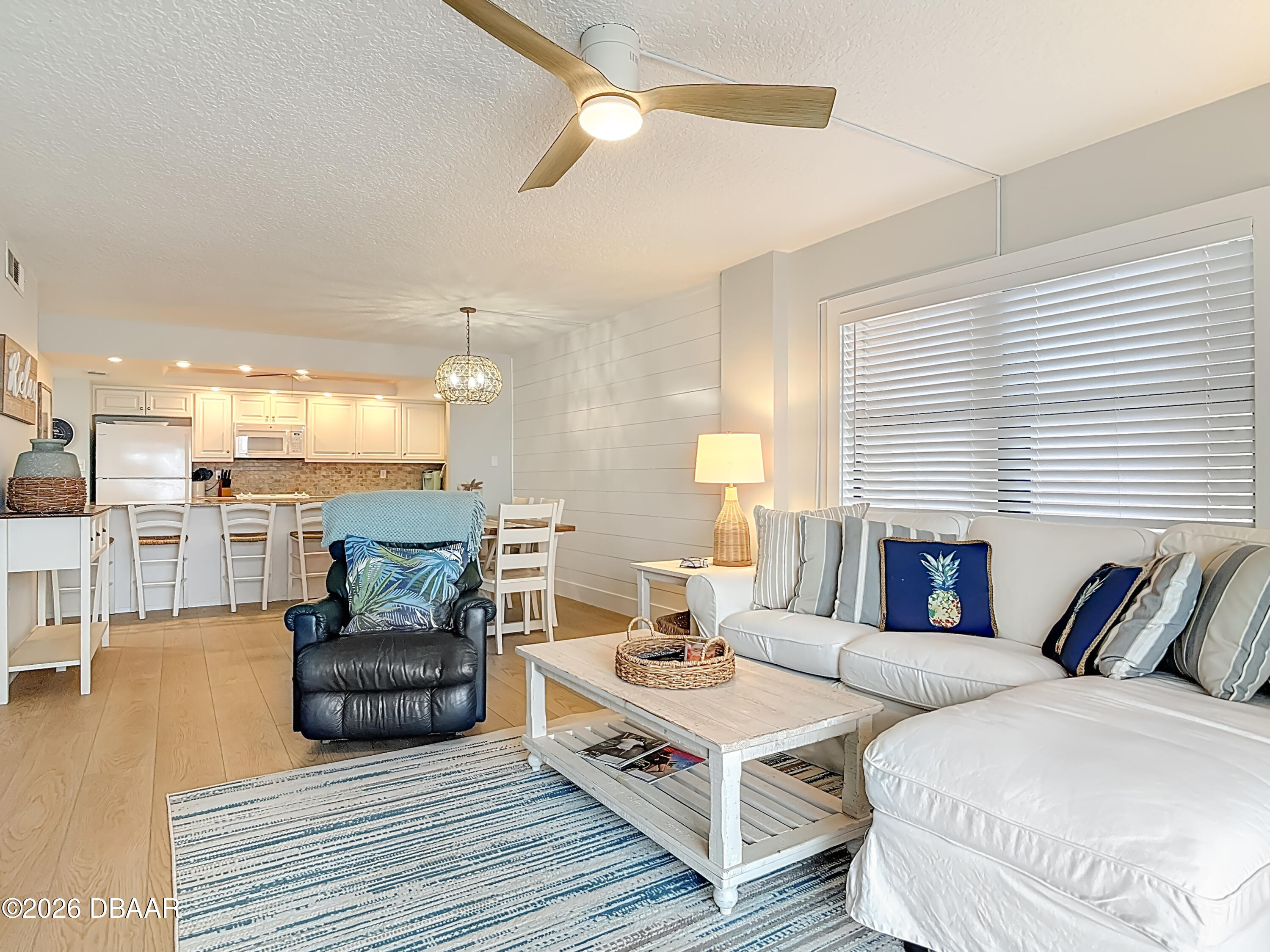 4445 South Atlantic Avenue, Unit 301 Ponce Inlet, FL 32127 - Photo 15 of 45 a living room with furniture and a wooden floor