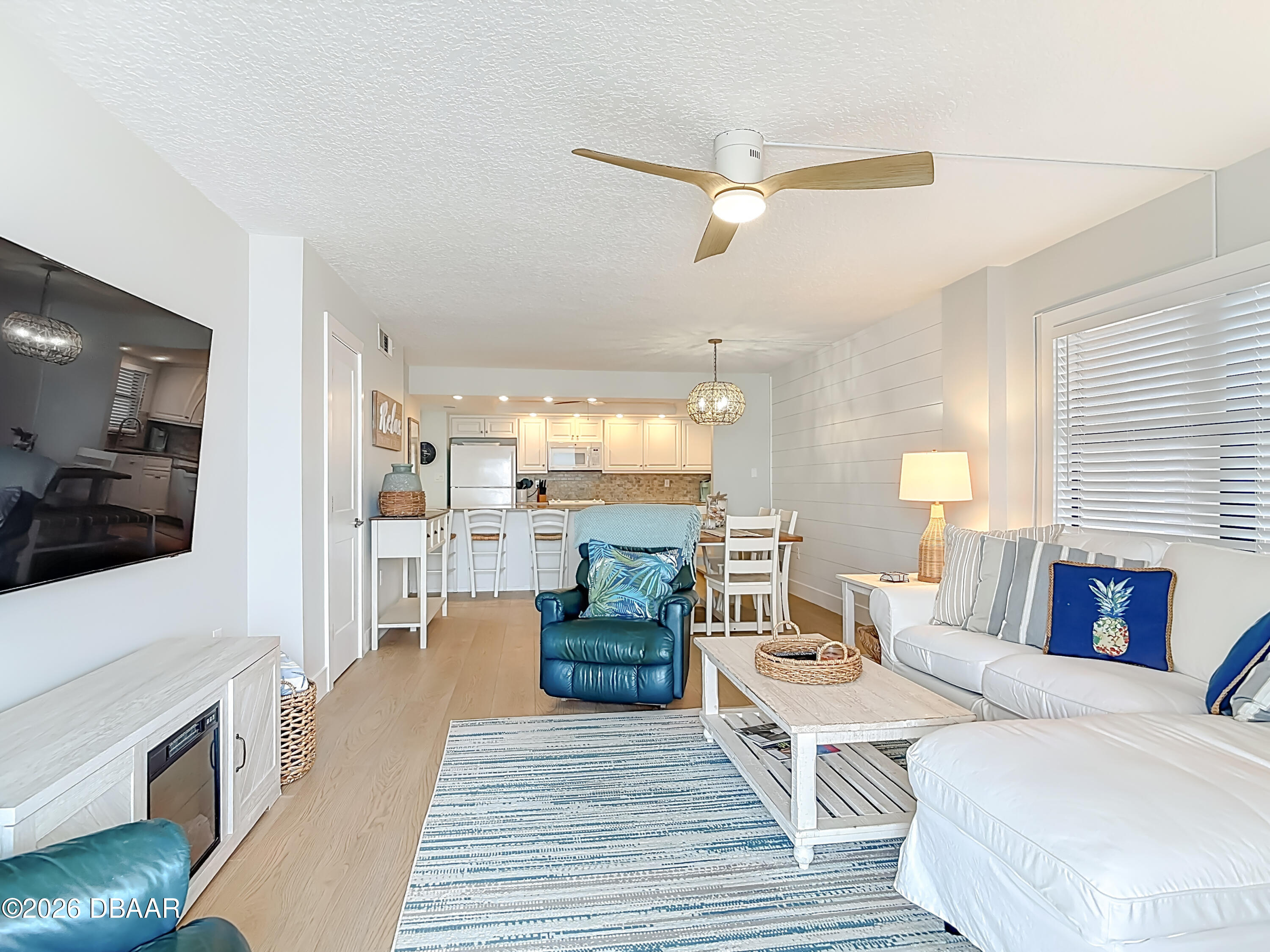 4445 South Atlantic Avenue, Unit 301 Ponce Inlet, FL 32127 - Photo 16 of 45 a living room with fireplace furniture and a wooden floor