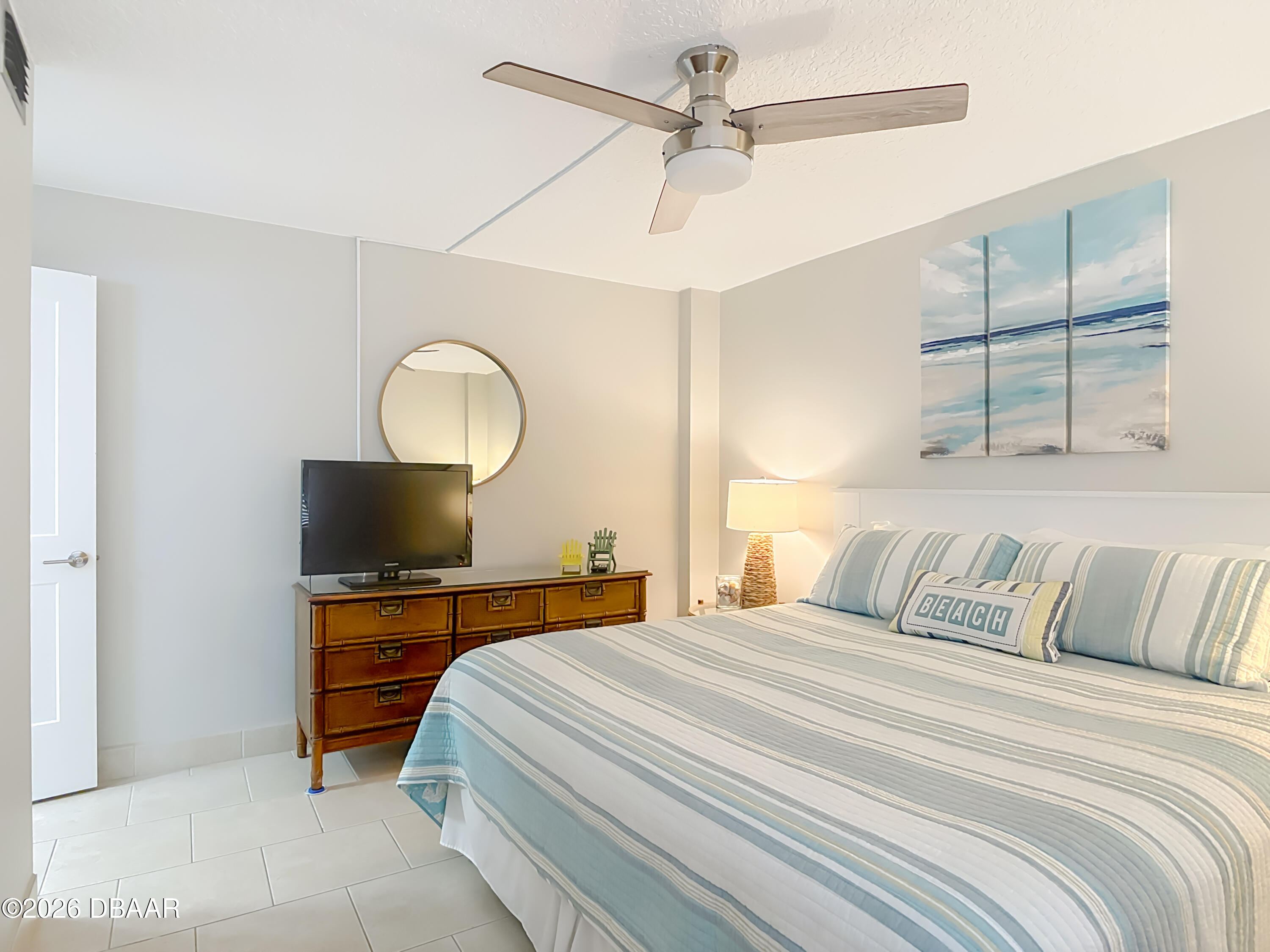4445 South Atlantic Avenue, Unit 301 Ponce Inlet, FL 32127 - Photo 20 of 45 a bedroom with a bed and a flat screen tv