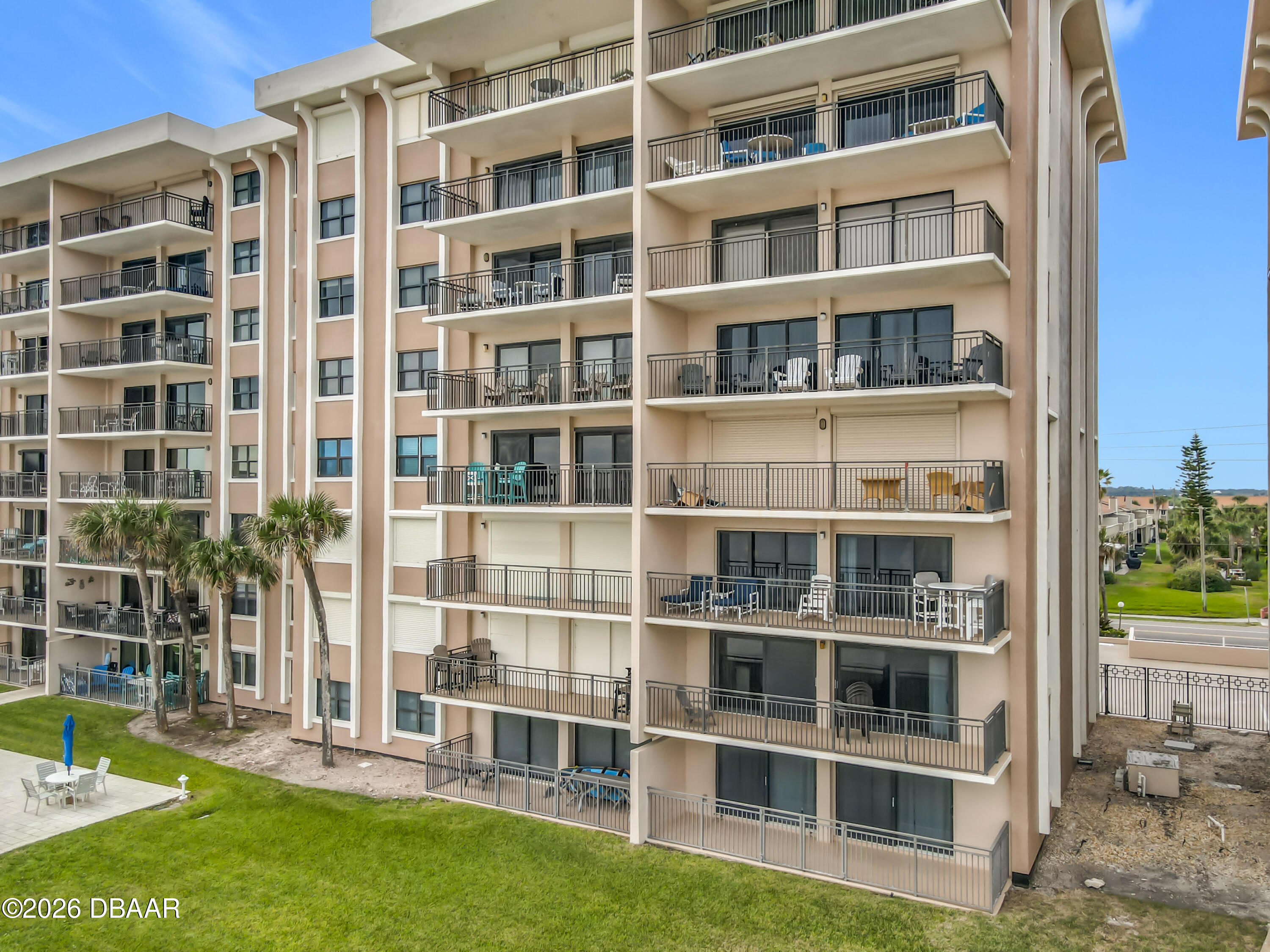 4445 South Atlantic Avenue, Unit 301 Ponce Inlet, FL 32127 - Photo 2 of 45 a view of front of a building with a yard