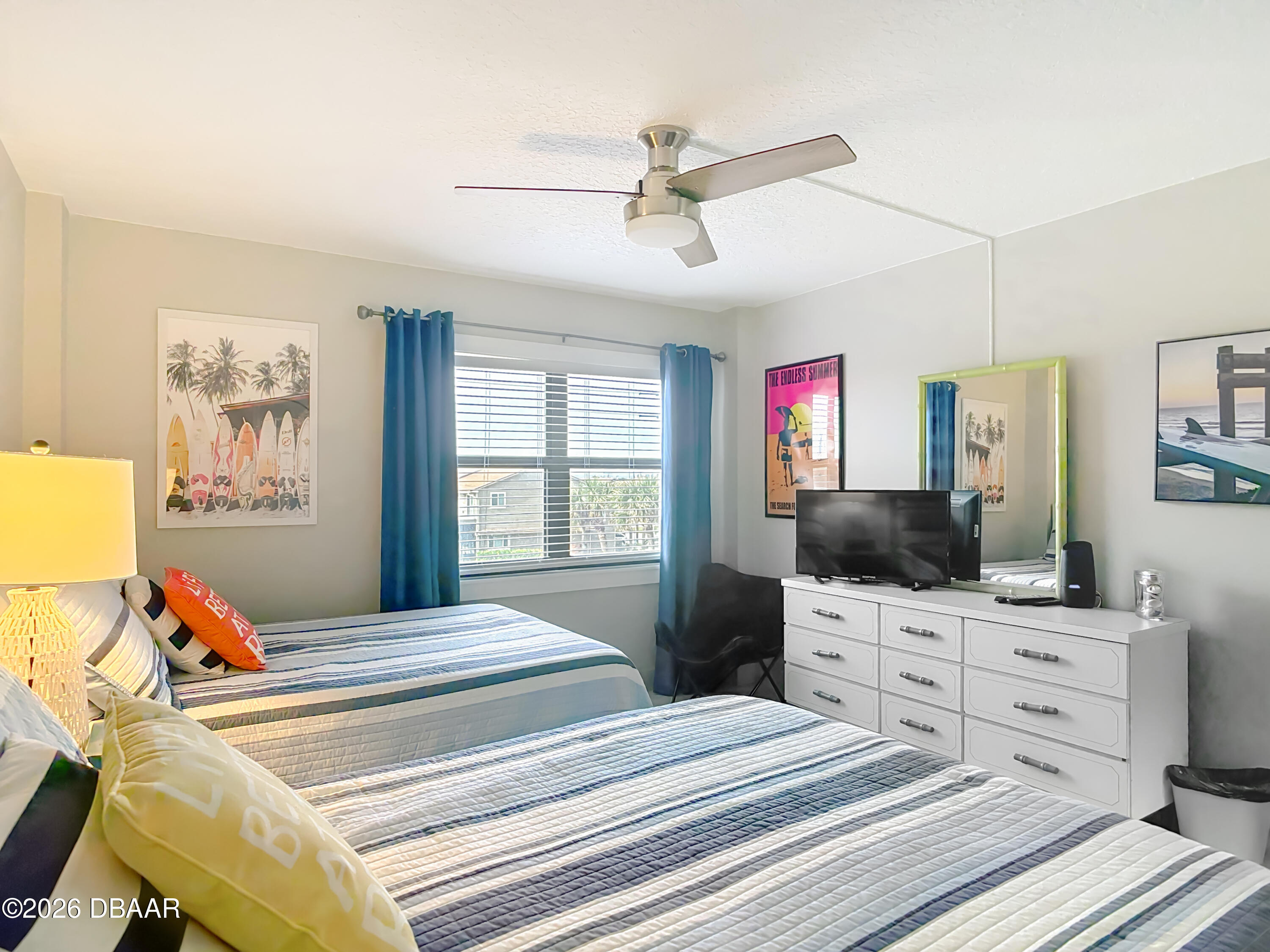 4445 South Atlantic Avenue, Unit 301 Ponce Inlet, FL 32127 - Photo 21 of 45 a bedroom with a bed and a flat screen tv