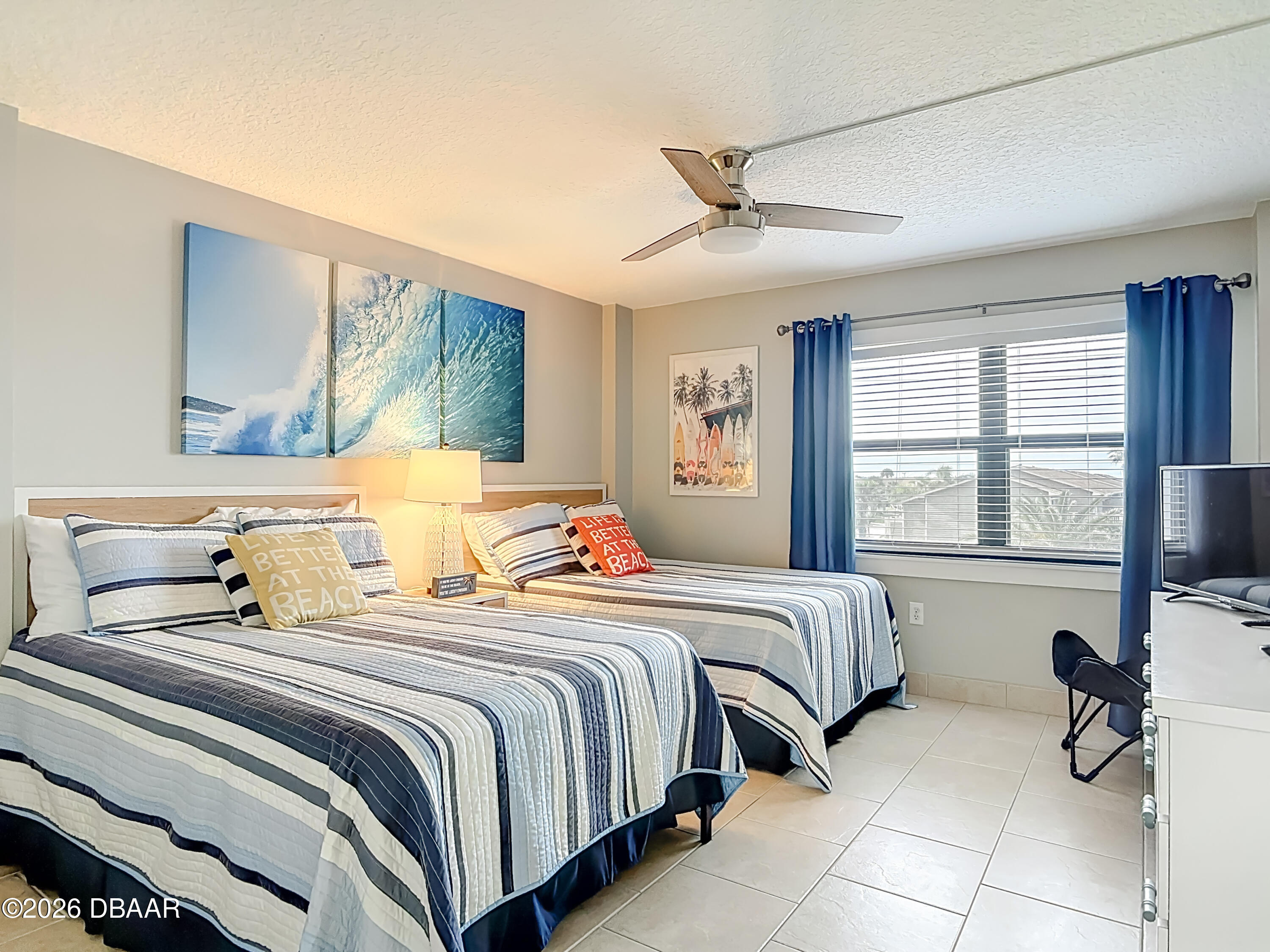 4445 South Atlantic Avenue, Unit 301 Ponce Inlet, FL 32127 - Photo 22 of 45 a bedroom with two beds and a large window