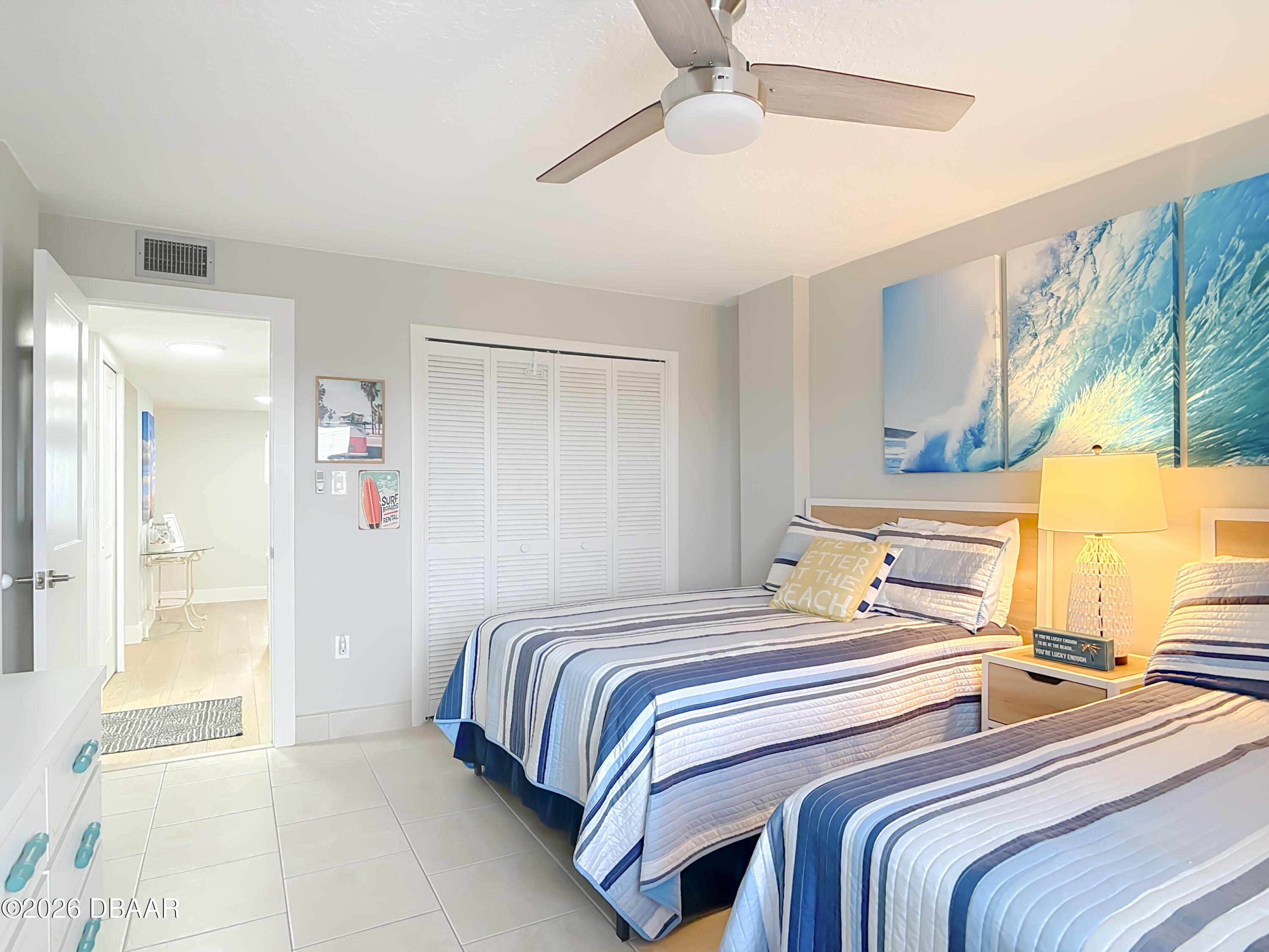 4445 South Atlantic Avenue, Unit 301 Ponce Inlet, FL 32127 - Photo 23 of 45 a bedroom with a bed and a chandelier