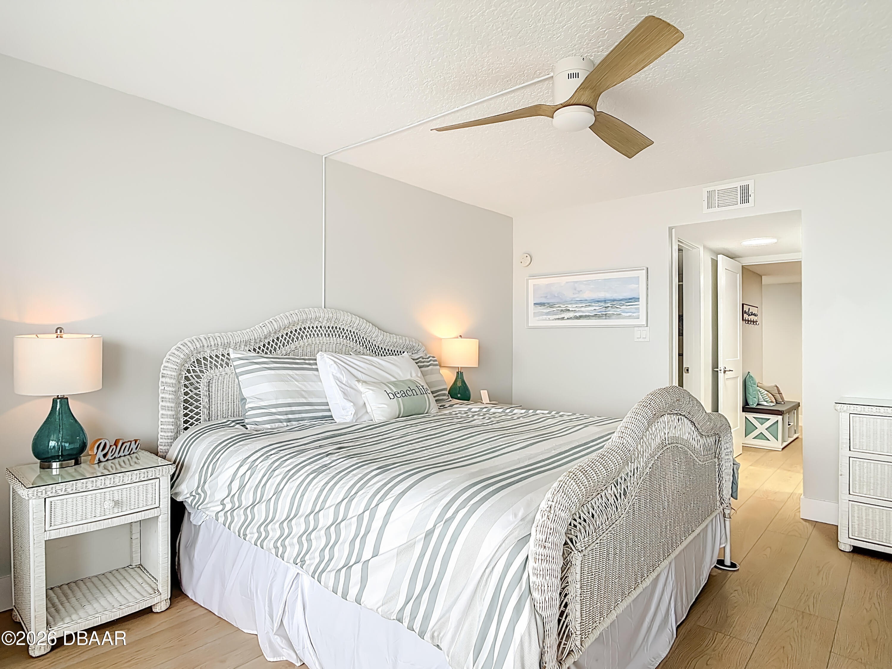 4445 South Atlantic Avenue, Unit 301 Ponce Inlet, FL 32127 - Photo 27 of 45 a bedroom with a bed and a chandelier