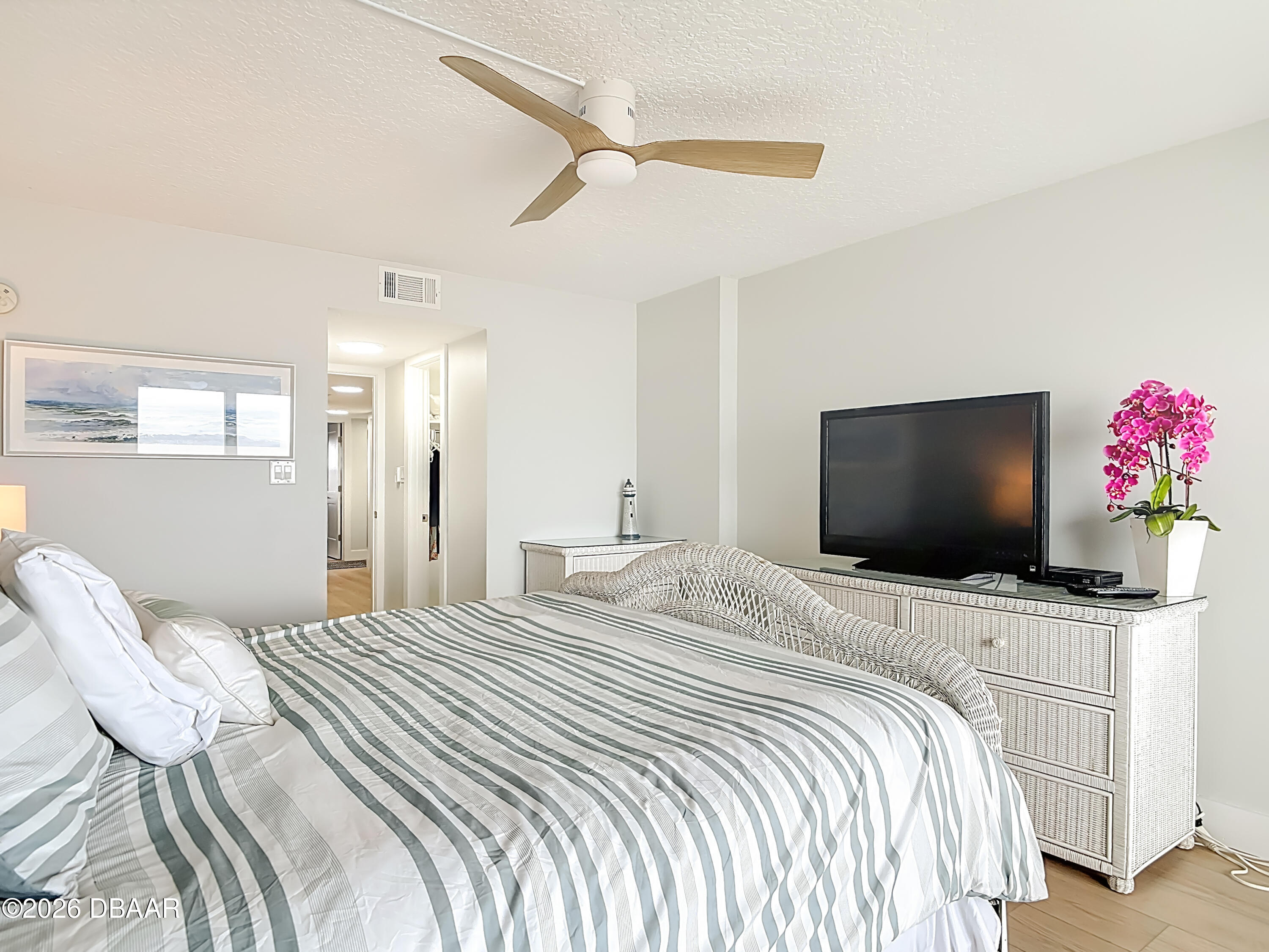 4445 South Atlantic Avenue, Unit 301 Ponce Inlet, FL 32127 - Photo 28 of 45 a bedroom with a bed and a flat screen tv