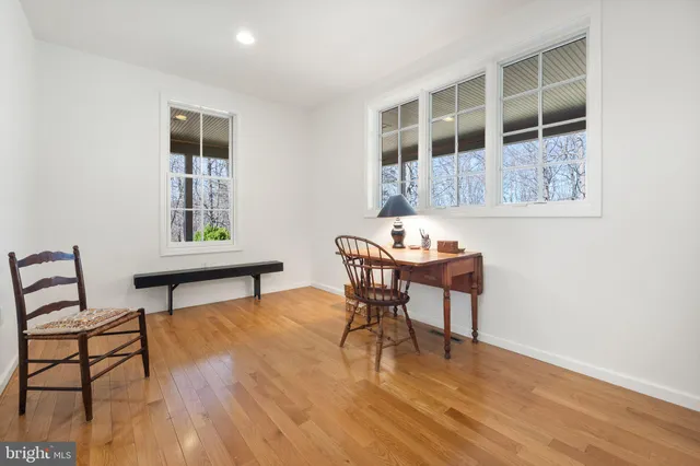 a living room with furniture a dining table and a fireplace