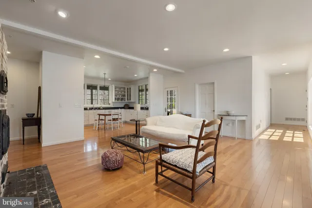 a view of empty room with wooden floor and window