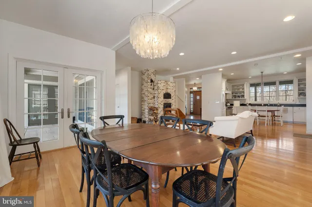 a spacious bedroom with a bed and wooden floor