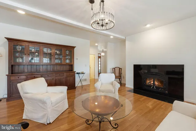 a view of a hallway with wooden floor and cabinet