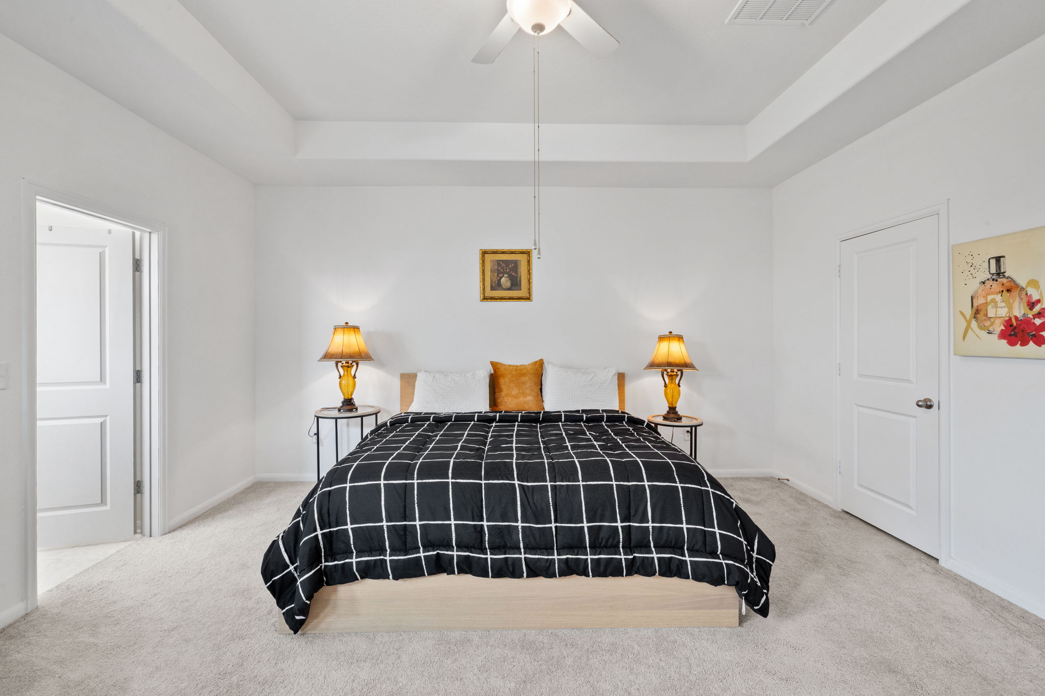 189 Durian Loop Buda, TX 78610 - Photo 15 of 38 Bedroom featuring a raised ceiling, light colored carpet, and ceiling fan