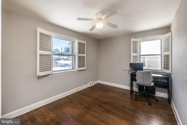 a workspace with wooden floor and a window
