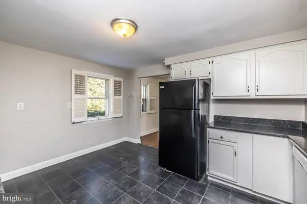 a kitchen with a refrigerator and a stove top oven