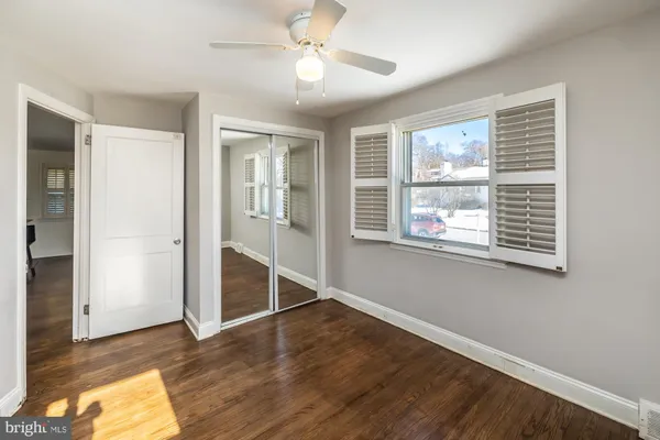 wooden floor in an empty room with a window