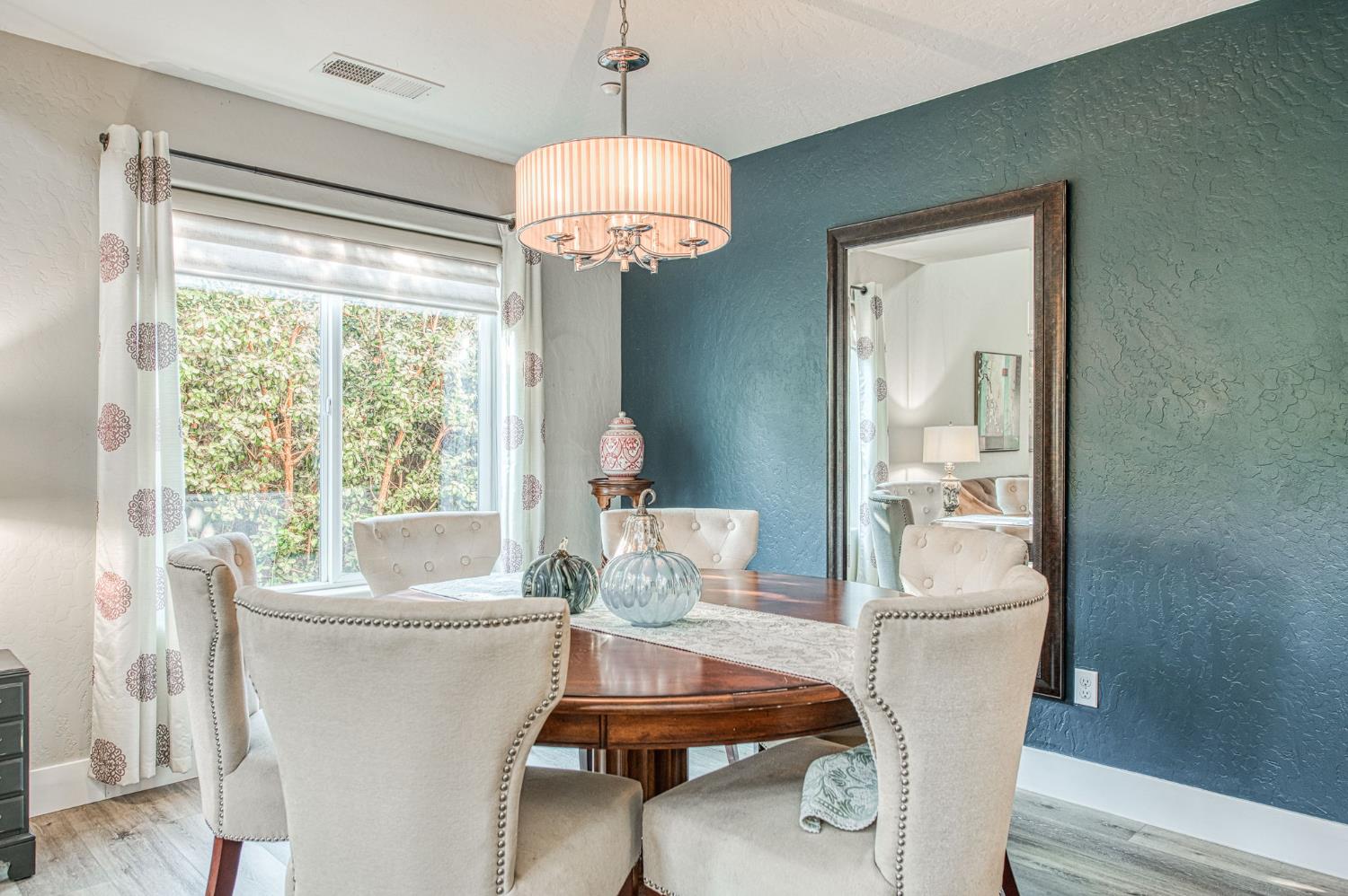 5855 East Platt Avenue Fresno, CA 93727 - Photo 21 of 57 a dining room with furniture a chandelier and wooden floor