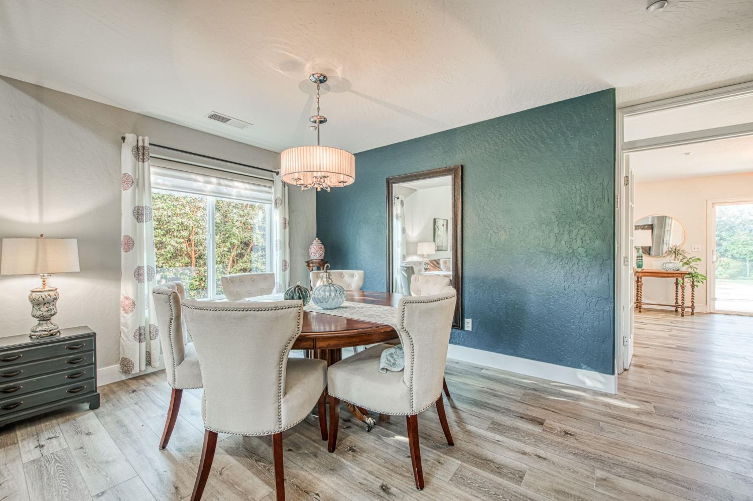 5855 East Platt Avenue Fresno, CA 93727 - Photo 22 of 57 a view of a dining room with furniture window and wooden floor