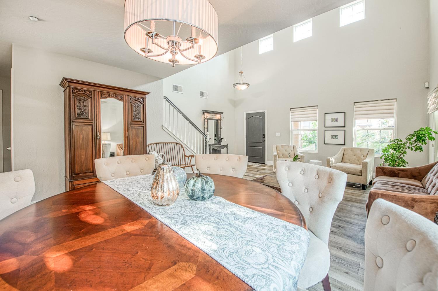5855 East Platt Avenue Fresno, CA 93727 - Photo 24 of 57 a view of a dining room with furniture a chandelier and wooden floor