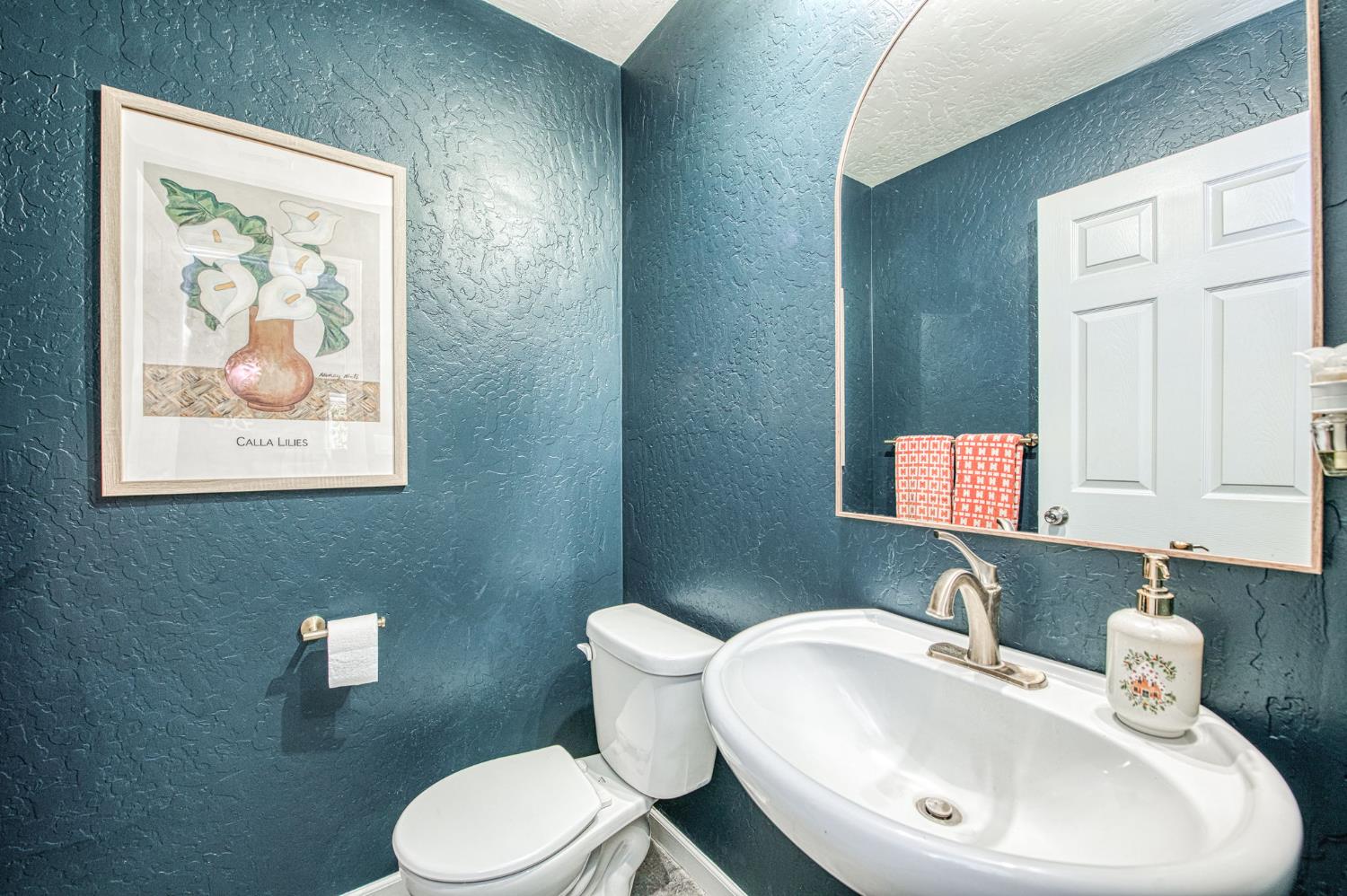 5855 East Platt Avenue Fresno, CA 93727 - Photo 25 of 57 a bathroom with a toilet a sink and mirror