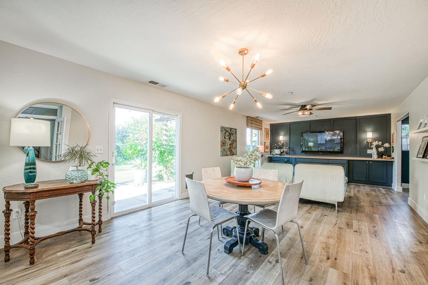 5855 East Platt Avenue Fresno, CA 93727 - Photo 26 of 57 a view of a dining room with furniture window and wooden floor