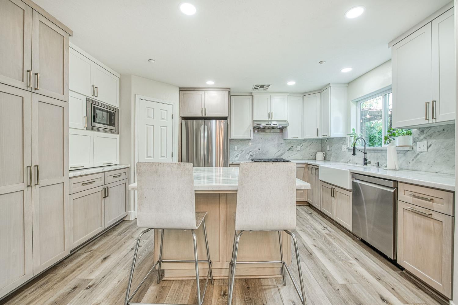 5855 East Platt Avenue Fresno, CA 93727 - Photo 29 of 57 a kitchen with white cabinets and stainless steel appliances