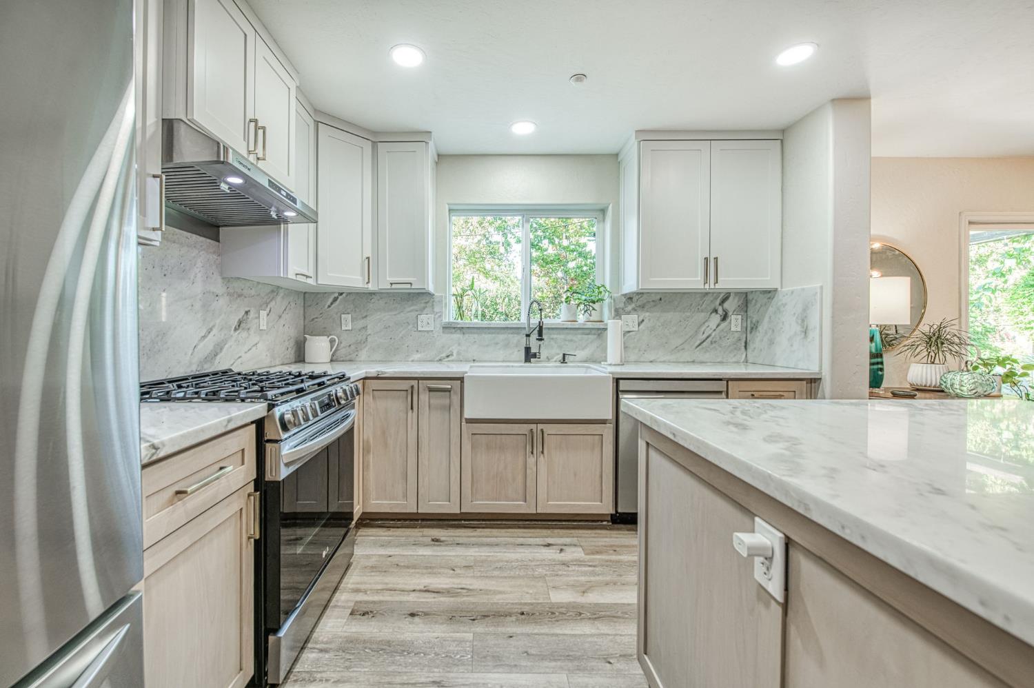 5855 East Platt Avenue Fresno, CA 93727 - Photo 32 of 57 a kitchen with stainless steel appliances granite countertop a sink stove and cabinets
