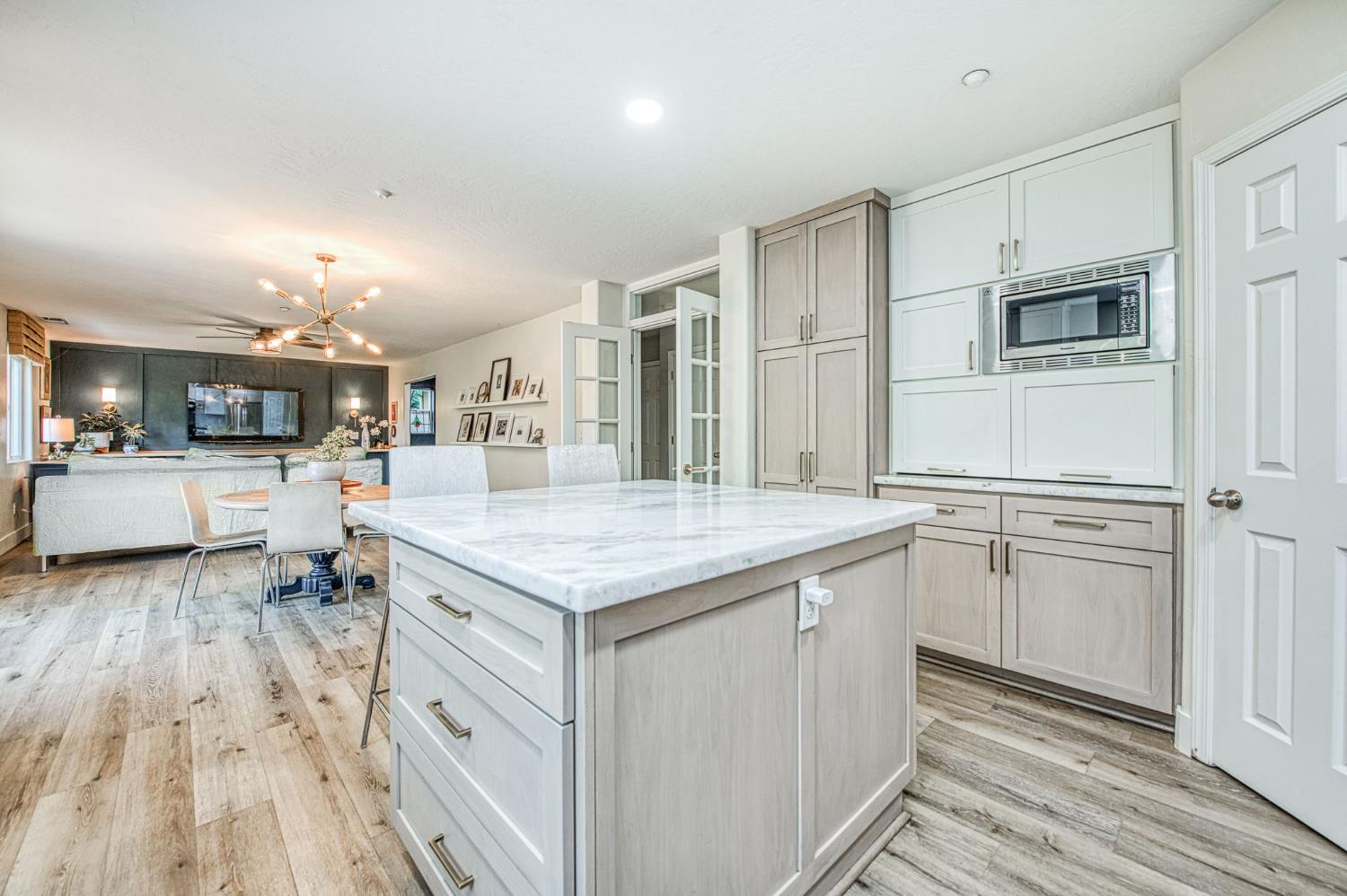 5855 East Platt Avenue Fresno, CA 93727 - Photo 35 of 57 a kitchen with stainless steel appliances granite countertop a lot of counter space and wooden floors