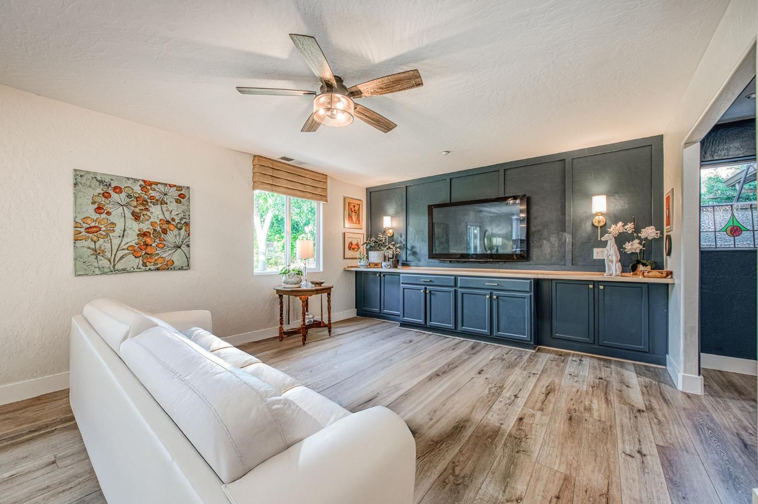 5855 East Platt Avenue Fresno, CA 93727 - Photo 38 of 57 a living room with furniture and a flat screen tv