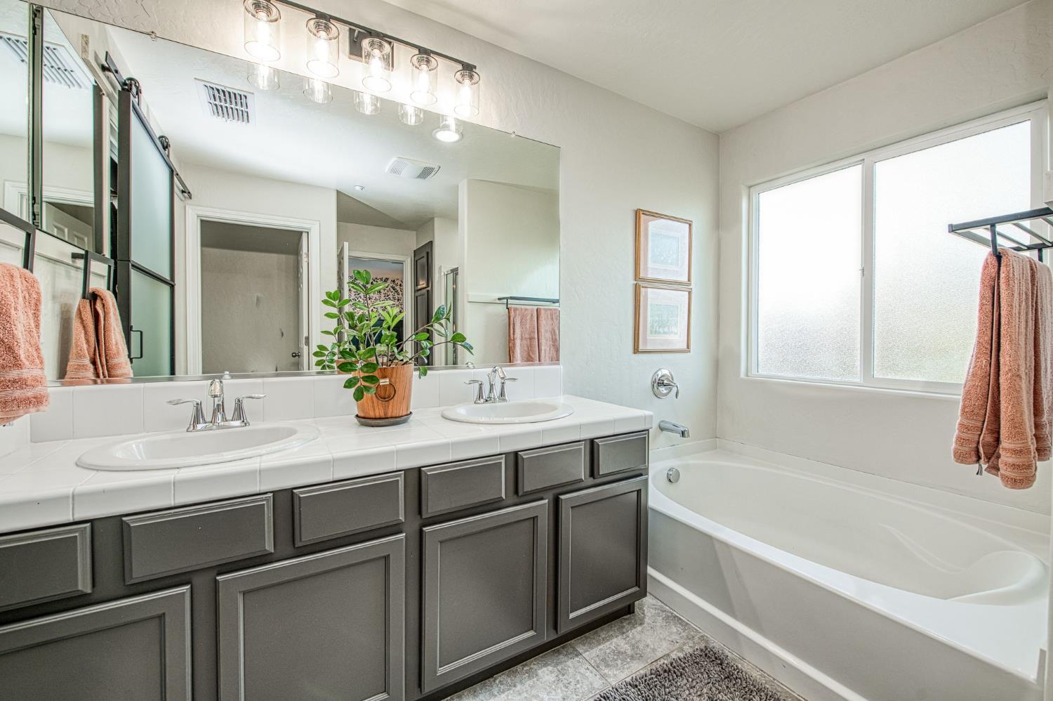 5855 East Platt Avenue Fresno, CA 93727 - Photo 45 of 57 a bathroom with a tub sink and mirror