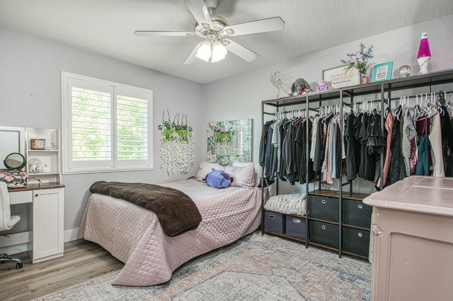 5855 East Platt Avenue Fresno, CA 93727 - Photo 47 of 57 a bedroom with a bed and a chandelier